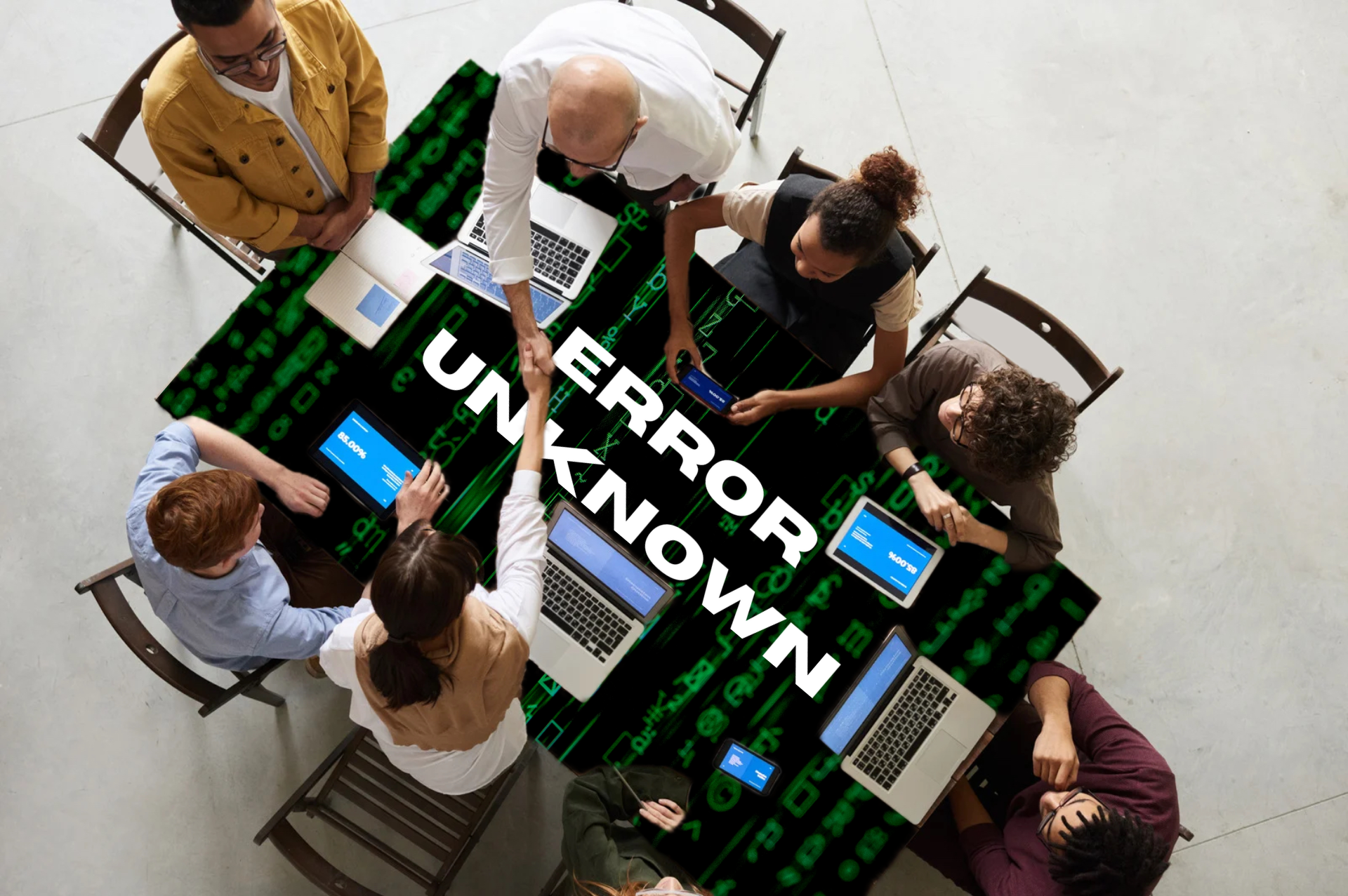 business people conducting a meeting around a table - table has green matrix code in back with white text "Error Unknown" superimposed